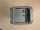 Side profile of a grey Anker power station showing an AC input, an orange charging port, and a cooling grille.