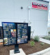 Outdoor drive-thru menu board with a speaker-mic housing at a Smokey Mo's TX BBQ restaurant.