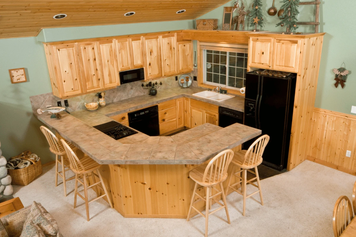 Knotty alder cabinetry in a rustic kitchen with breakfast bar