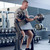 Eleiko Curl Bar - 50 mm, 12 kg with an athlete performing seated bicep curls in a training facility