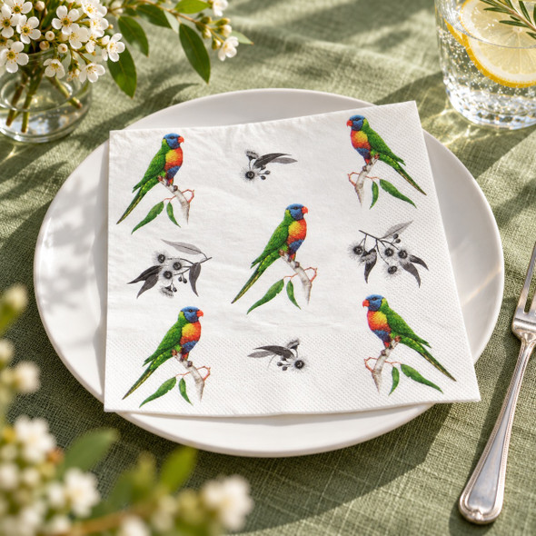 Australian Rainbow Lorikeet paper napkin displayed on a white dinner plate with sage green table linen, white flowers, crystal glassware and silver cutlery