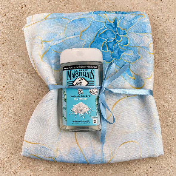 Soft blue floral cotton viscose shawl with Le Petit Marseillais Sea Salt Shower Gel tied with a light blue ribbon