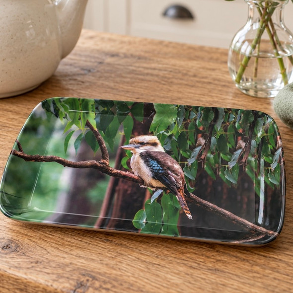Small kookaburra melamine serving tray, 24 × 16 cm, on a wooden table with eucalyptus foliage