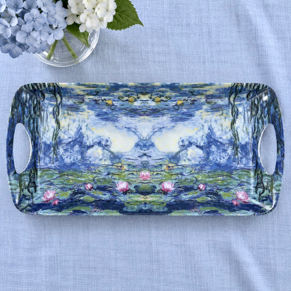 Water lilies melamine sandwich tray, 40 × 20 cm, on light blue linen beside hydrangeas