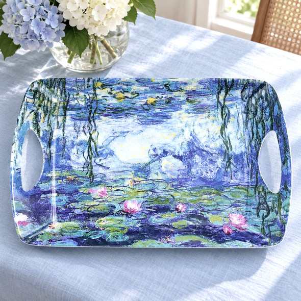 Claude Monet Water Lilies large melamine serving tray, 48 × 33 cm, on light blue linen beside hydrangeas