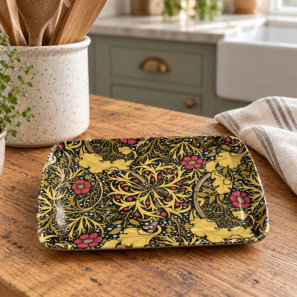 William Morris Seaweed small melamine serving tray, 24 × 16 cm, with golden foliage and red flowers on a dark background