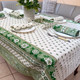 250 x 150 cm rectangular stain-resistant coated French tablecloth in Bastide Green design with green floral and paisley patterns, matching French napkins and bread basket, made in France