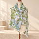 Draped scarf: Lightweight green checked scarf draped over the shoulders of a cream mannequin.