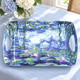 Claude Monet Water Lilies large melamine serving tray, 48 × 33 cm, on light blue linen beside hydrangeas