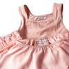 Iron-on baby name label securely attached to a soft cotton bib for nursery