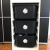 Round write-on labels on toy storage bins labeled with contents