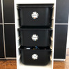 Round write-on labels on toy storage bins labeled with contents
