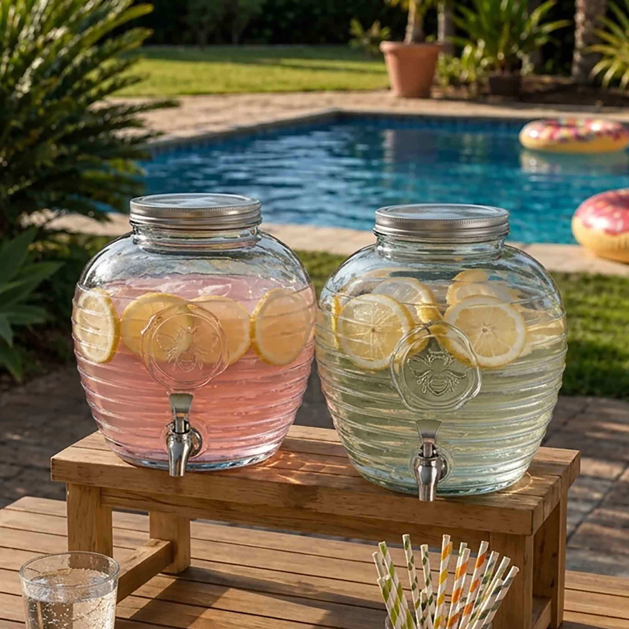 Bee Quenched Glass Drink Dispenser on Table at Pool Party for Summer Celebration or Birthday
