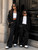 Two 10 and 12 year old  stylish girls wearing luxury black oversized suits with gold accessories and mini handbags in a modern editorial fashion scene inspired by elevated kids street style and contemporary luxury fashion.