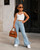 3 years old years old Latina girl modeling Cool Kids Bklyn light wash flare jeans with khaki mini handbag and sunglasses on Fifth Avenue NYC