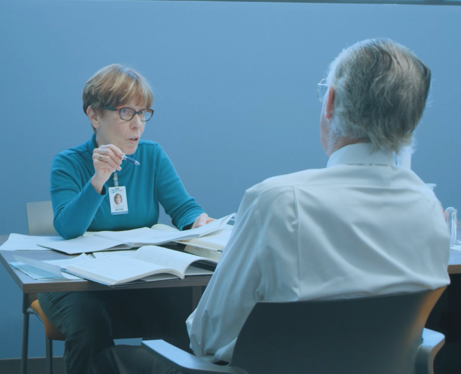 Two staff members having discussion at a table