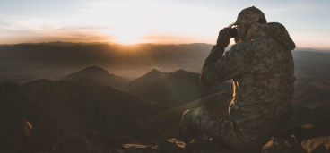 Man with Binoculars on Sunny Ridge