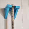 Teal Baseball Bat Hanger mounted on wall with bat