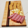 charcuterie on a solid maple and zebrawood cutting board