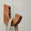 solid mahogany wall hook mounted on the wall with a purse hanging from it