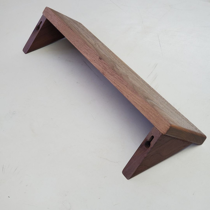 keyholes in the back of the corbels allow for easy concealed hanging of this 16 inch solid walnut wood shelf