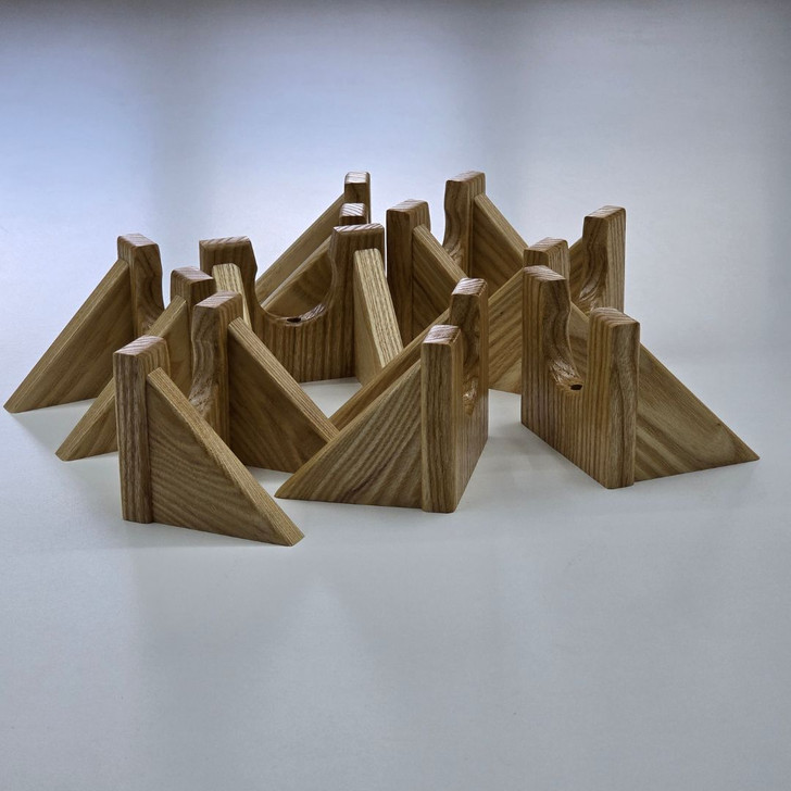 batch of solid ash wood wall hangers for guitars pictured on white table