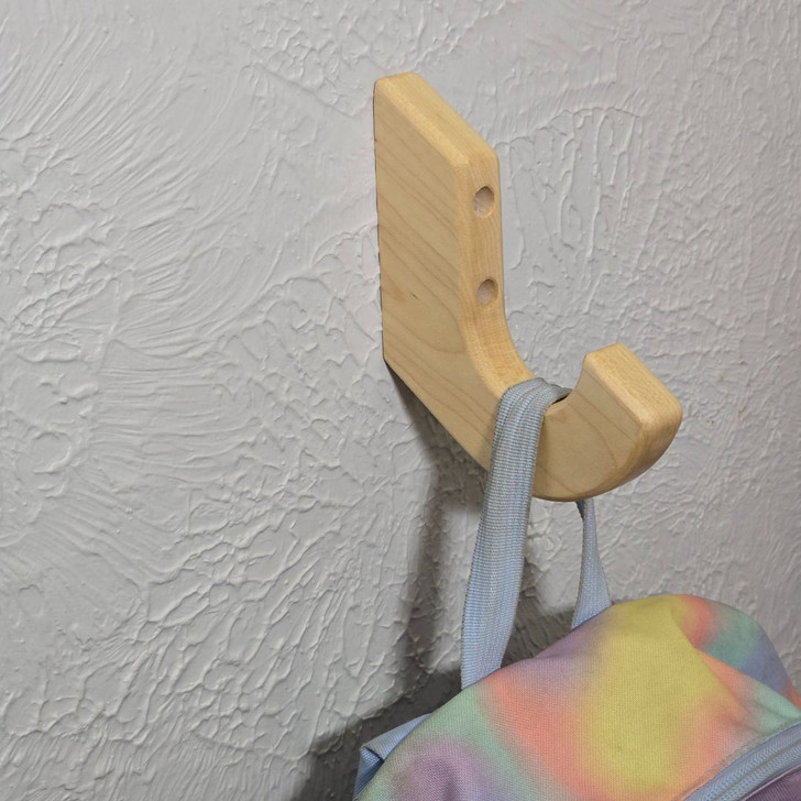 solid maple wood hook with backpack hanging on the wall