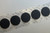 Image of a strip of 1 3/8'' Black Hook Coins with Acrylic 72 Adhesive VELCRO® Brand Hook and Loop Fasteners available at iTapeStore.com