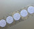 Image of a strip of 1 3/8'' White Hook Coins with Acrylic 72 Adhesive VELCRO® Brand Hook and Loop Fasteners available at iTapeStore.com