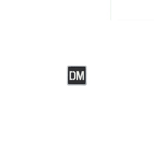 Small black and white velcro patch saying DM
