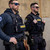 Police officers wearing tactical vests with navy buildable placard base and front ID panels Police officers wearing tactical vests with navy buildable placard base and front ID panels