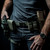 A fully built out military tactical style Defense mechanisms combat belt in ranger green