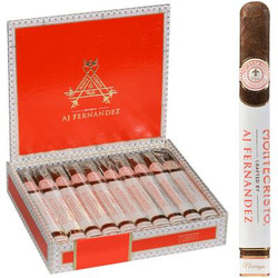Montecristo Crafted By Aj Fernandez Cigars Churchill 10 Ct. Box 7.00X50, featuring a partially opened luxurious red cigar box filled with ten cigars, with one cigar standing upright outside the box. Montecristo Crafted By Aj Fernandez Cigars Churchill 10 Ct. Box 7.00X50, featuring a partially opened luxurious red cigar box filled with ten cigars, with one cigar standing upright outside the box.