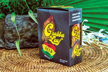 Grabba Leaf Tobacco Grabba Leaf Wraps Red Gold Green Edition 25ct, product packaging with colorful branding design on a textured surface, surrounded by natural elements.