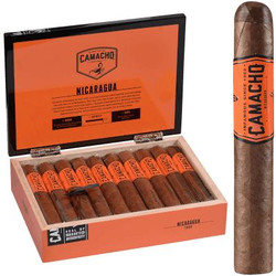 Camacho Nicaragua Cigar Toro 20 Ct. Box, an open box displaying 20 cigars with orange and black branding and one cigar shown outside the box for display. Camacho Nicaragua Cigar Toro 20 Ct. Box, an open box displaying 20 cigars with orange and black branding and one cigar shown outside the box for display.