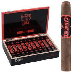 Camacho Corojo Bxp Cigar Toro Tubos 20 Ct. Box, an image of a cigar box filled with 20 cigars and a single cigar standing upright showing its band. Camacho Corojo Bxp Cigar Toro Tubos 20 Ct. Box, an image of a cigar box filled with 20 cigars and a single cigar standing upright showing its band.