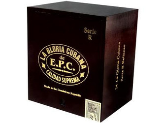 La Gloria Cubana Cigars Serie R Belicoso Natural (No Cello) 24 Ct. Box 5.75X56, a black wooden cigar box with gold lettering and a small QR code, showcasing the packaging of premium cigars.