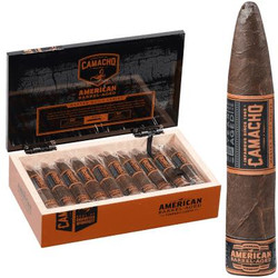 Camacho American Barrel-Aged Torpedo Corto Cigars 20 Ct. Box, open cigar box displaying 20 cigars with a cigar standing upright outside the box. Camacho American Barrel-Aged Torpedo Corto Cigars 20 Ct. Box, open cigar box displaying 20 cigars with a cigar standing upright outside the box.