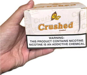 Grabba Leaf Tobacco Grabba Leaf Crushed 25Ct, a small white box with a warning label and a yellow logo on top, held in a person's hand. Grabba Leaf Tobacco Grabba Leaf Crushed 25Ct, a small white box with a warning label and a yellow logo on top, held in a person's hand.