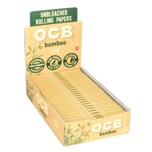 OCB Bamboo Cigarette Papers 1 1/4 Plus Tips 24/20 Ct. Box, image of a box filled with unbleached bamboo smoking papers with individual sheets displayed for use.