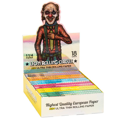 Lion Rolling Circus Ultra Thin Rolling Papers 1 1/4, colorful assorted packs of ultra thin rolling papers for cigarettes or herbs displayed in an open box with a clown figure on the packaging.