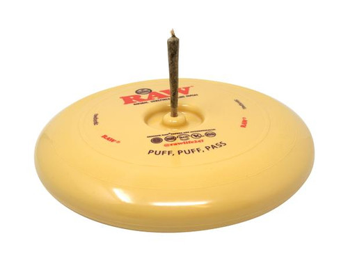 RAW Flying Disc Cone Holder, yellow plastic disc with a inserted brown candle