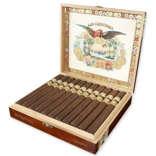 San Cristobal Cigars, an open wooden box with cigars arranged inside and colorful artwork on the lid depicting a bird with a cigar in its beak and coins.