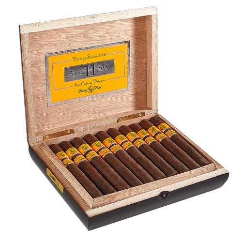 Rocky Patel Vintage 2006 Cigars, a wooden presentation box containing 11 aged cigars with yellow and black bands.
