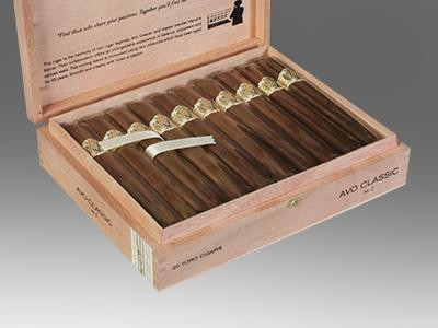 AVO Cigars Classic No. 2 Toro 20 Ct. Box 6.00X50, wooden cigar box containing 20 cigars with gold bands, arranged in two rows of 10, with a white ribbon at the side.