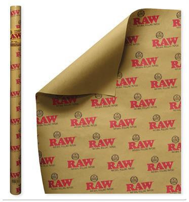 RAW Wrapping Paper, roll of brown kraft paper with RAW logo print in red and gold, partially unrolled showing design and texture.