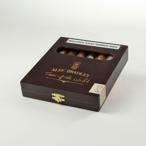 Alec Bradley Taste Of The World Sampler 8 Ct, cigar sampler box with a window showing assorted cigars inside, dark brown packaging with gold lettering and logo, for cigar enthusiasts.