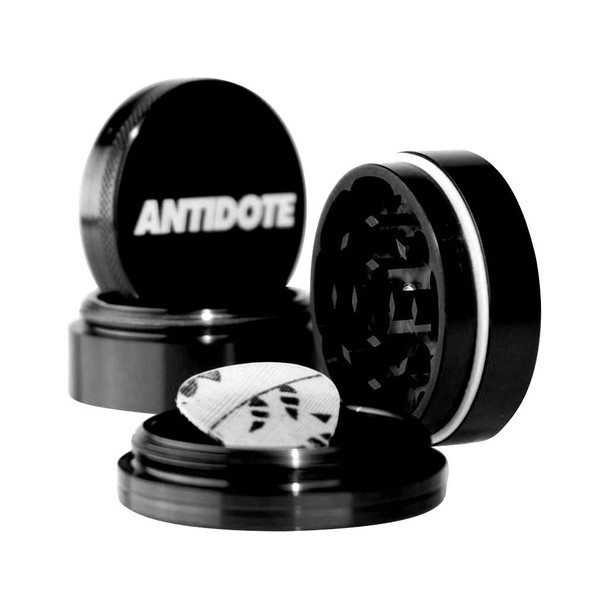 Antidote 4 Piece Grinder 2.5, a black four-piece herb grinder with a removable screen, sharp teeth, and a storage compartment, designed for grinding dried herbs evenly.