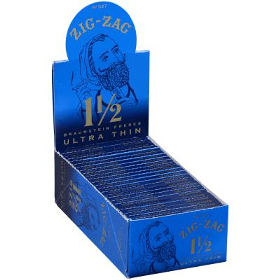 Republic Group Zig Zag Ultra Thin Blue Cigarette Papers 1 1/2, open blue box with multiple packs of ultra thin cigarette rolling papers inside. Republic Group Zig Zag Ultra Thin Blue Cigarette Papers 1 1/2, open blue box with multiple packs of ultra thin cigarette rolling papers inside.