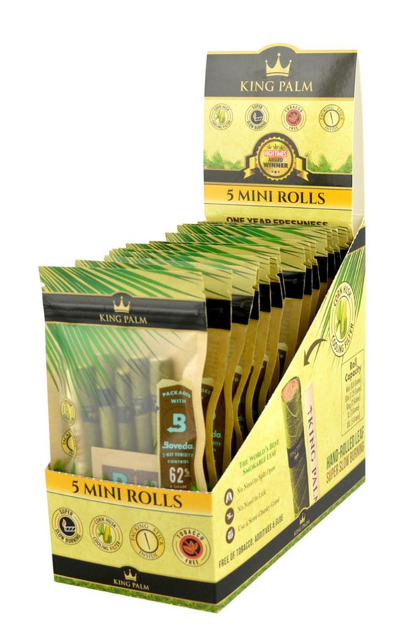 King Palm Wraps King Palm Mini Rolls 15/5PK, display of a box containing multiple packs of mini rolls for hand-rolling. The packaging is yellow and green with branding and product information visible.